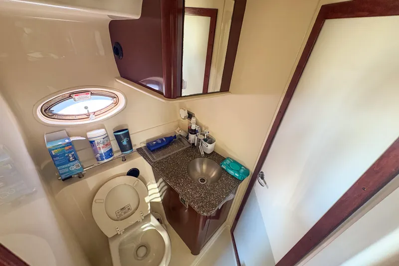 Slide: The Image of Bathroom interior of 2008 Sea Ray 380 Sundancer yacht, featuring sink and toilet. - 54