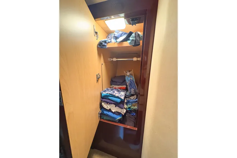 Slide: The Image of Cabinet with folded clothes inside a 2008 Sea Ray 380 Sundancer yacht. - 59
