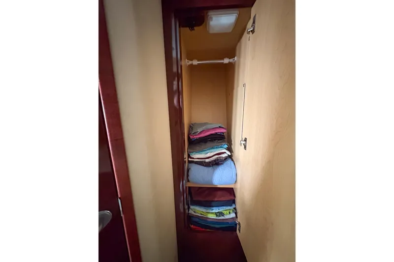 Slide: The Image of Closet interior on 2008 Sea Ray 380 Sundancer with neatly folded clothes. - 60
