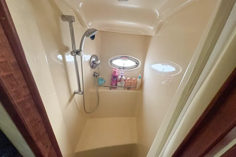 Slide: The Image of Shower area in 2008 Sea Ray 380 Sundancer yacht with porthole and toiletries. - 62