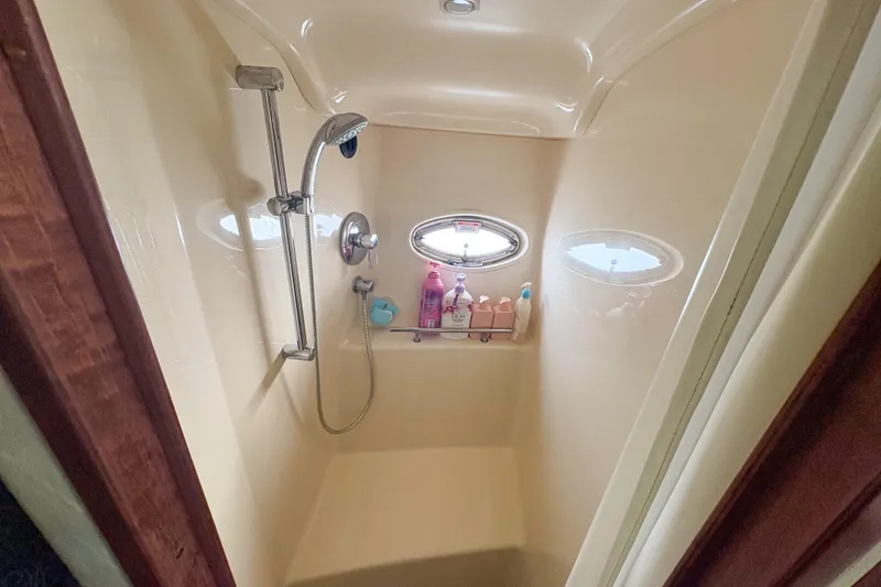 Slide: The Image of Shower area in 2008 Sea Ray 380 Sundancer yacht with porthole and toiletries. - 63