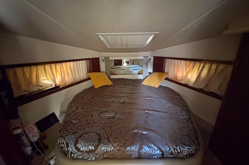 Slide: The Image of Luxurious cabin interior of 2008 Sea Ray 380 Sundancer with elegant bedding and soft lighting. - 67