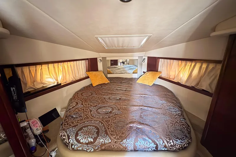 Slide: The Image of Luxurious cabin interior of 2008 Sea Ray 380 Sundancer with elegant bedding and soft lighting. - 68