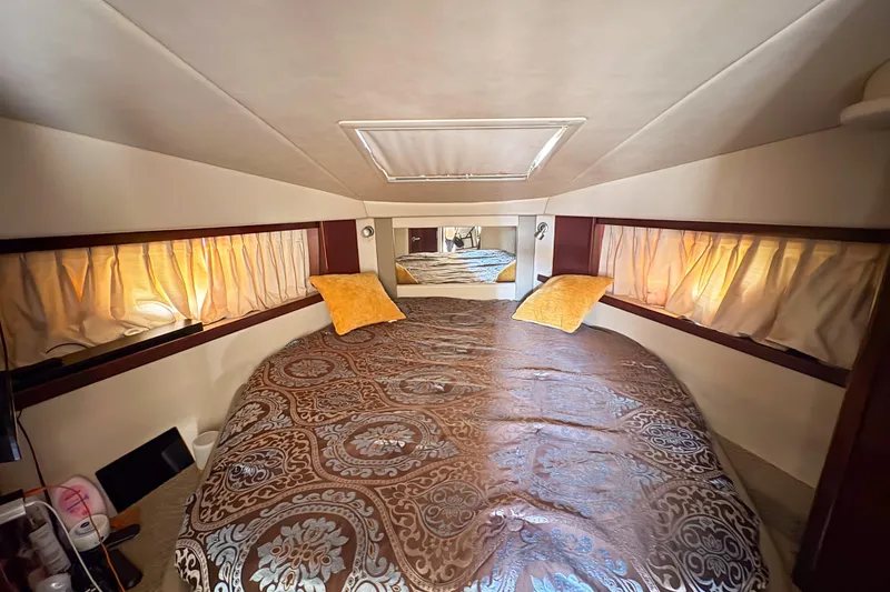 Slide: The Image of Luxurious cabin interior of 2008 Sea Ray 380 Sundancer with elegant bedding and soft lighting. - 69
