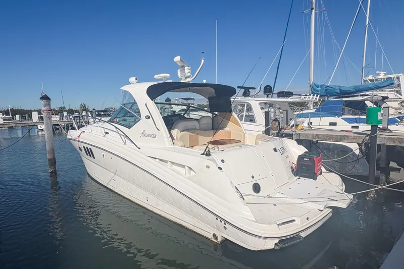 Slide: The Image of 2008 Sea Ray 380 Sundancer yacht docked at a marina under clear blue skies. - 7