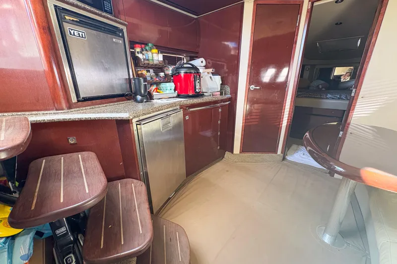 Slide: The Image of Interior of 2008 Sea Ray 380 Sundancer yacht with kitchen and seating area. - 72