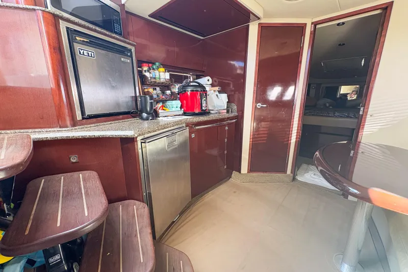 Slide: The Image of Interior of 2008 Sea Ray 380 Sundancer yacht with kitchen and dining area. - 73