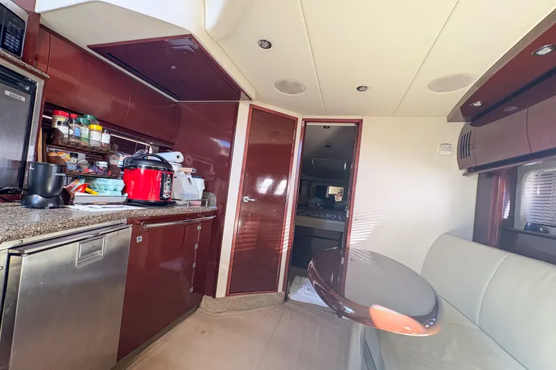 Slide: The Image of Interior of 2008 Sea Ray 380 Sundancer yacht with kitchen and seating area. - 74