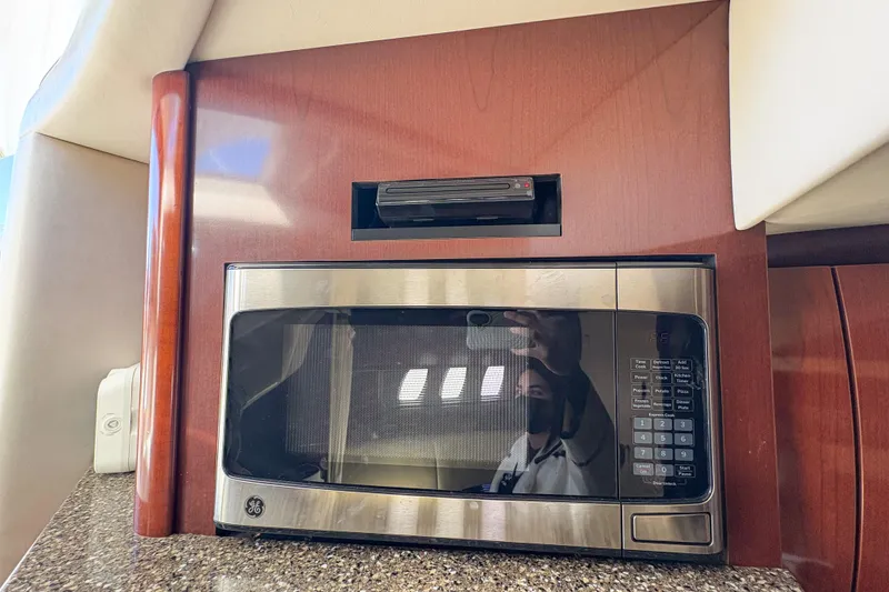 Slide: The Image of Microwave in 2008 Sea Ray 380 Sundancer yacht kitchen with wood paneling. - 75
