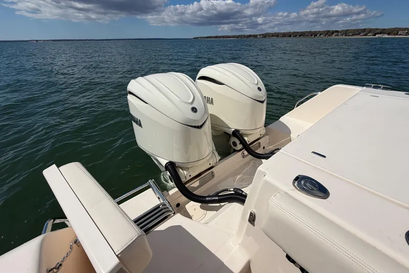 Slide: The Image of 2026 Grady-White Canyon 306 boat with dual Yamaha outboard engines on open water. - 11