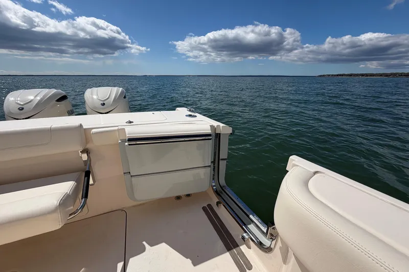 Slide: The Image of 2026 Grady-White Canyon 306 boat on open water under a blue sky. - 12