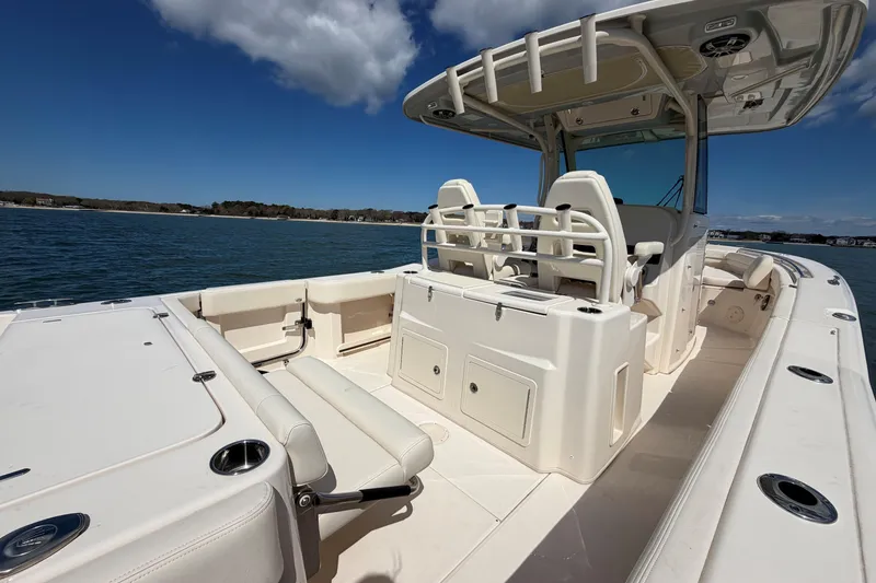 Slide: The Image of 2026 Grady-White Canyon 306 boat on water, featuring spacious deck and seating. - 13