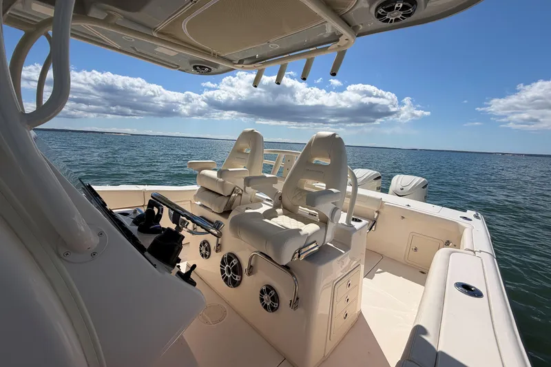 Slide: The Image of 2026 Grady-White Canyon 306 boat interior with ocean view, featuring comfortable seating. - 17