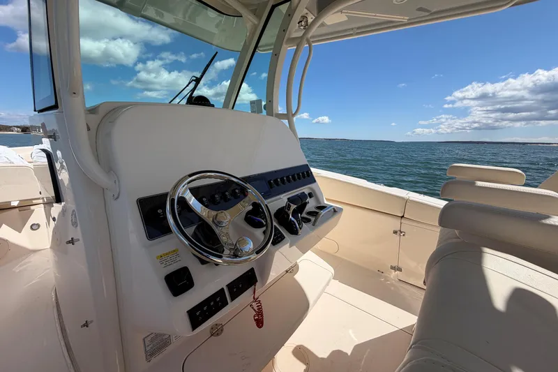 Slide: The Image of 2026 Grady-White Canyon 306 boat helm with ocean view and clear sky. - 20