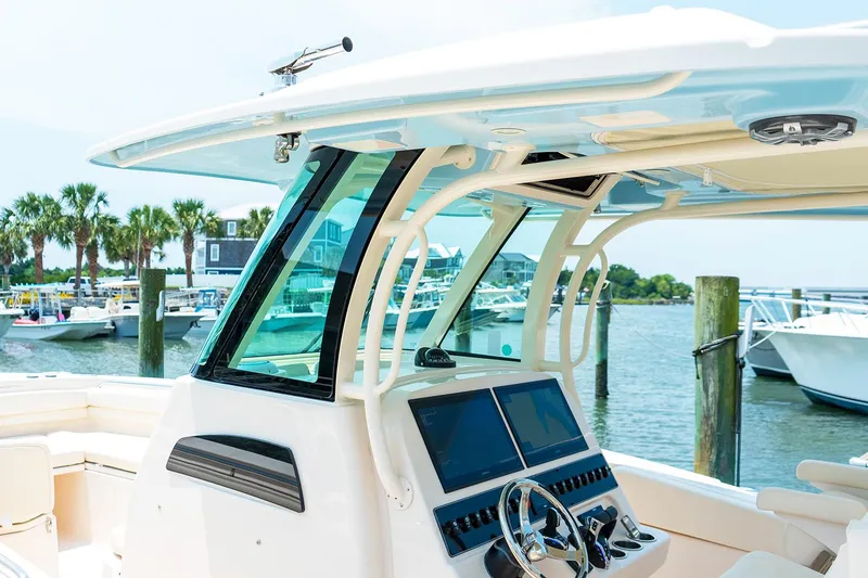 Slide: The Image of Manufacturer Provided Image: 2025 Grady-White Canyon 306 boat dashboard with modern controls, docked at a marina. - 6