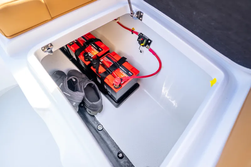 Slide: The Image of Battery compartment of Yellowfin 36 Offshore 2026 with shoes. - 16