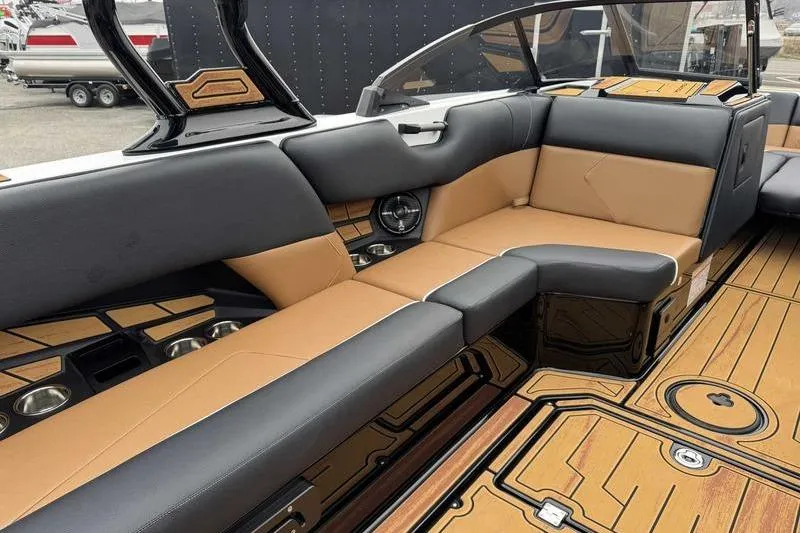 Slide: The Image of 2026 Moomba Tykon boat interior with luxurious tan and black seating. - 11