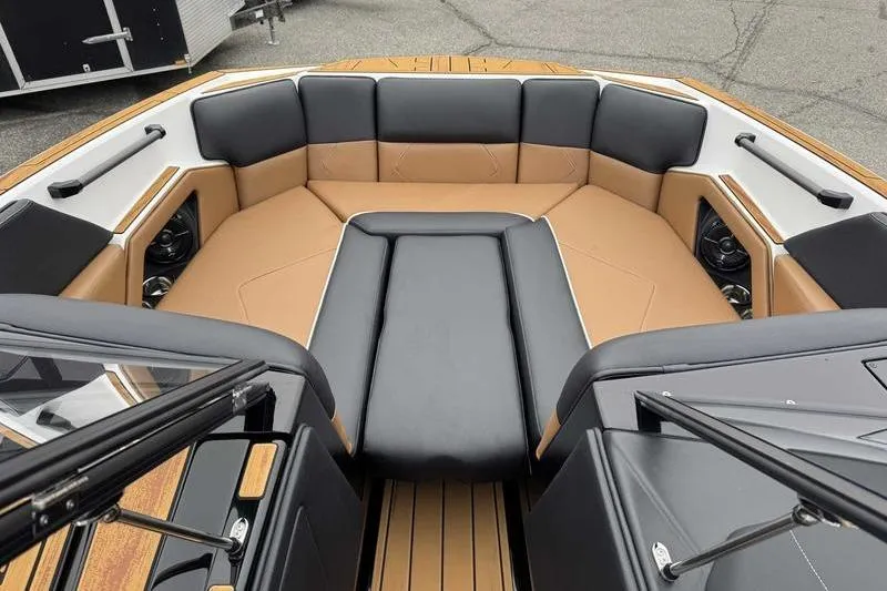 Slide: The Image of 2026 Moomba Tykon boat interior with tan and black seating, showcasing modern design. - 12