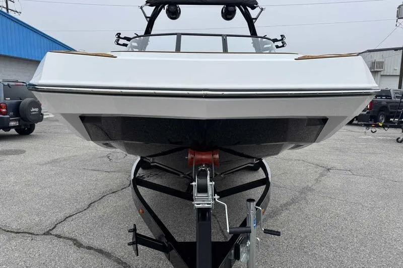 Slide: The Image of 2026 Moomba Tykon boat on trailer, front view in parking lot. - 4