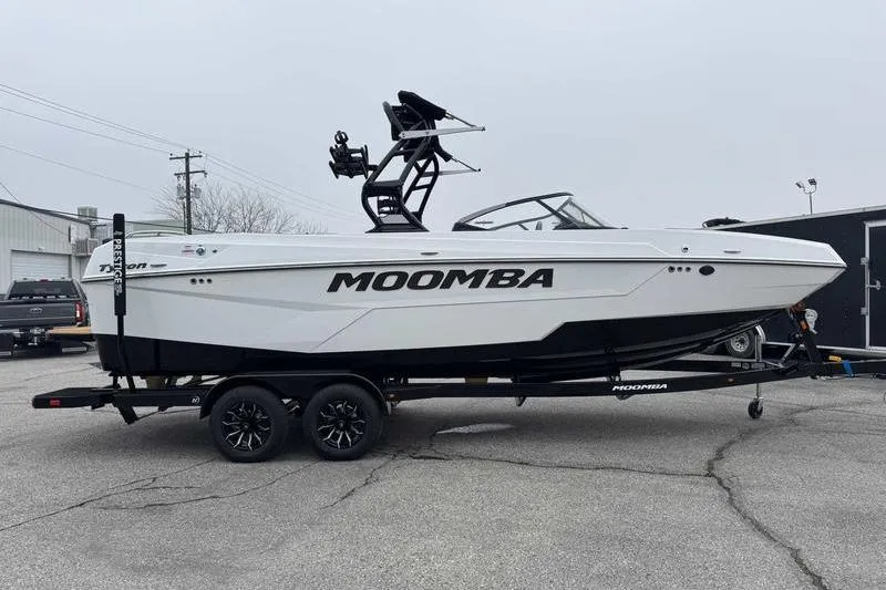 Slide: The Image of 2026 Moomba Tykon boat on trailer, sleek design, parked outdoors. - 5