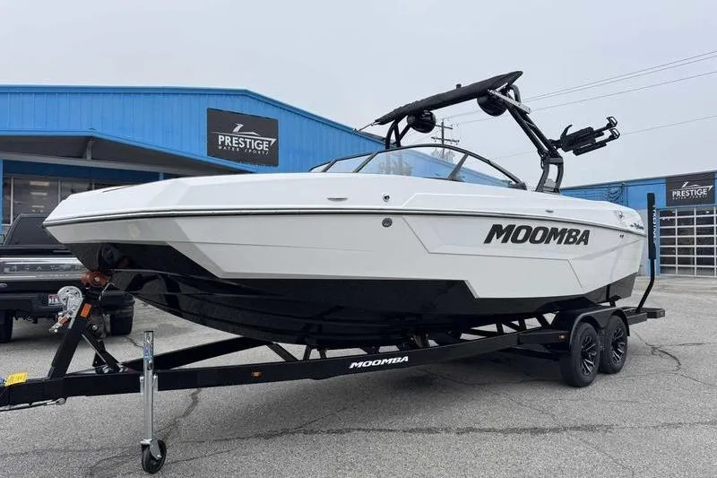Slide: The Image of 2026 Moomba Tykon boat on trailer at dealership, showcasing sleek design. - 7