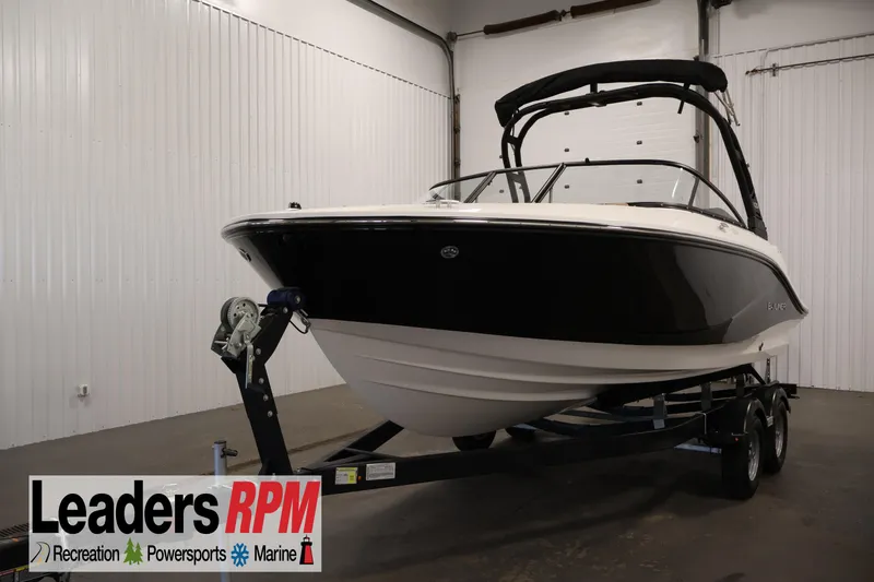 Slide: The Image of 2026 Bayliner V20i boat on trailer in indoor showroom. - 0