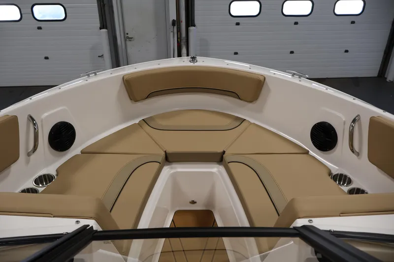 Slide: The Image of 2026 Bayliner V20i boat interior with tan seating and cup holders. - 10