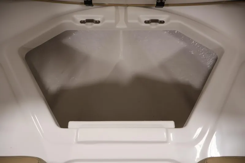 Slide: The Image of 2026 Bayliner V20i boat storage compartment, white interior, open hatch. - 11