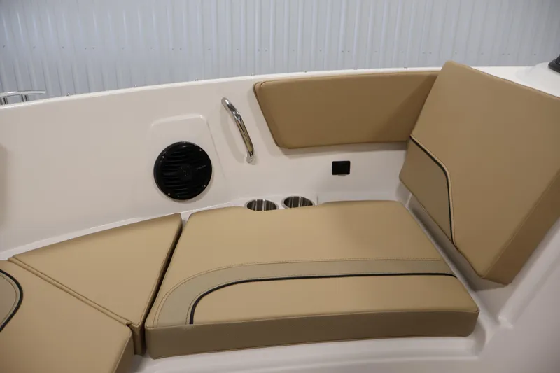 Slide: The Image of 2026 Bayliner V20i boat interior with tan seating and cup holders. - 14