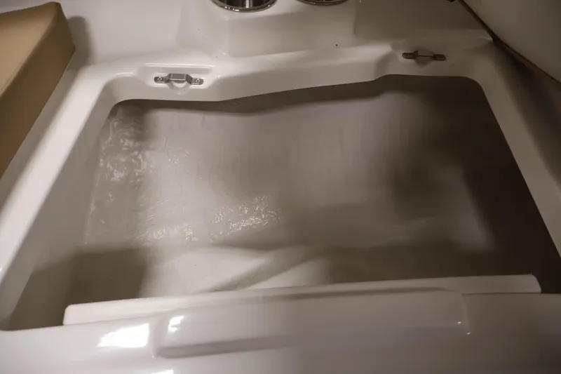 Slide: The Image of 2026 Bayliner V20i boat interior storage compartment, featuring sleek white design. - 15