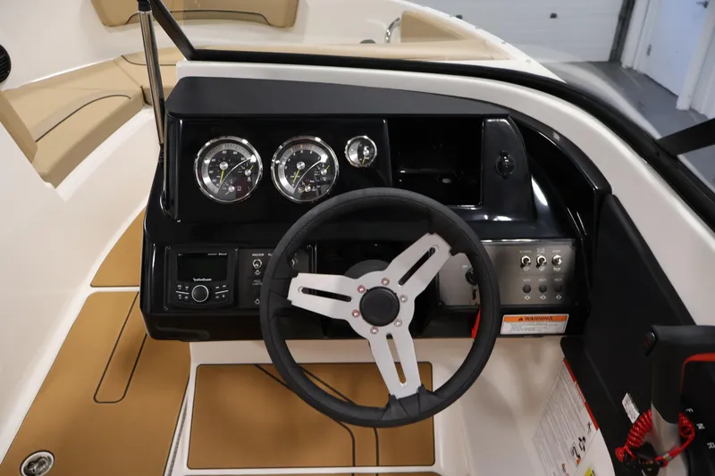 Slide: The Image of 2026 Bayliner V20i boat dashboard with steering wheel and instrument panel. - 17