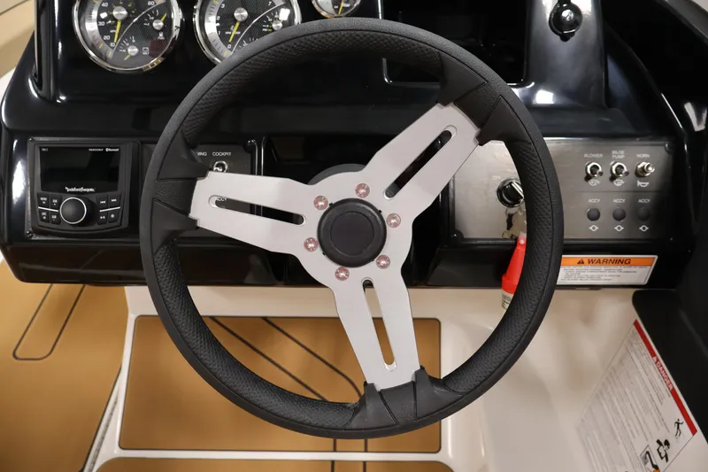 Slide: The Image of Steering wheel and dashboard of 2026 Bayliner V20i boat with modern controls. - 18