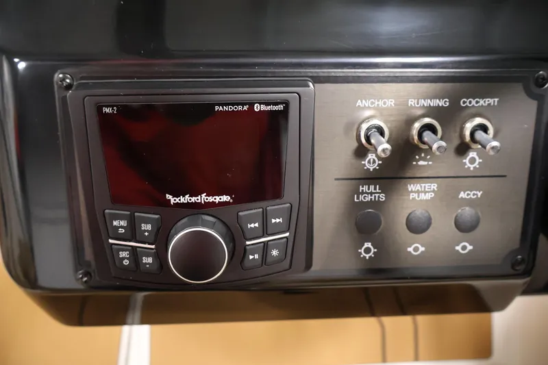 Slide: The Image of Control panel of 2026 Bayliner V20i boat with Rockford Fosgate audio system and switches. - 21