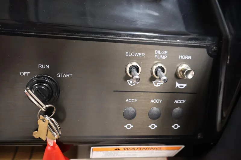 Slide: The Image of Control panel of 2026 Bayliner V20i boat with ignition and switches. - 22