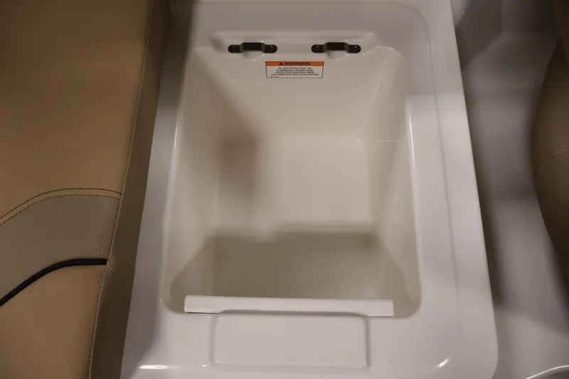 Slide: The Image of 2026 Bayliner V20i boat storage compartment with beige seating detail. - 30