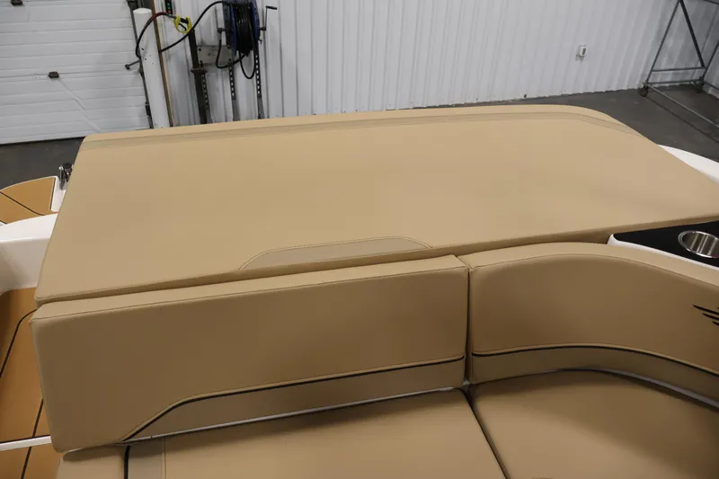 Slide: The Image of 2026 Bayliner V20i boat interior with tan leather seating and cup holder. - 31