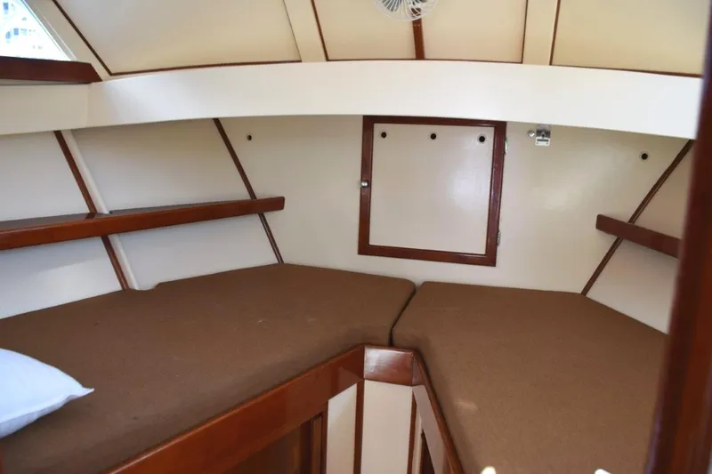 Slide: The Image of Shelves and reading lights in V-berth, trimmed with teak in Herreshoff styling - 21