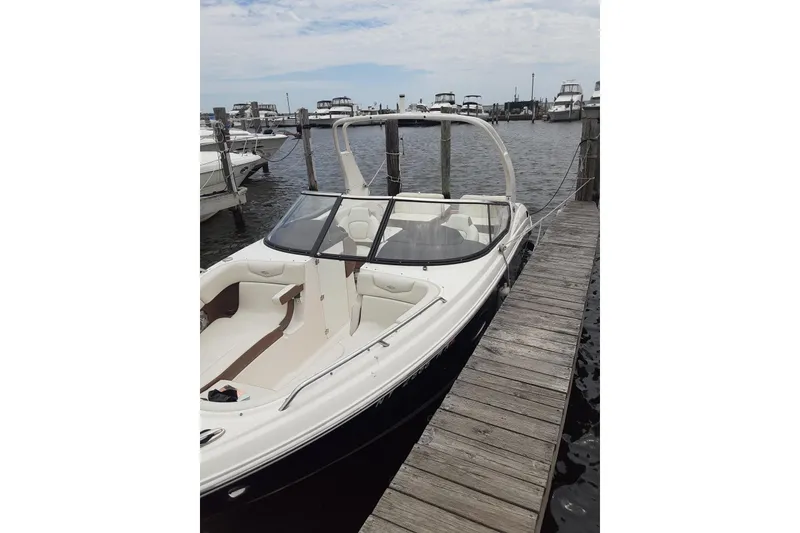 Slide: The Image of 2017 Chaparral 257 SSX boat docked at marina, featuring sleek design and spacious seating. - 1