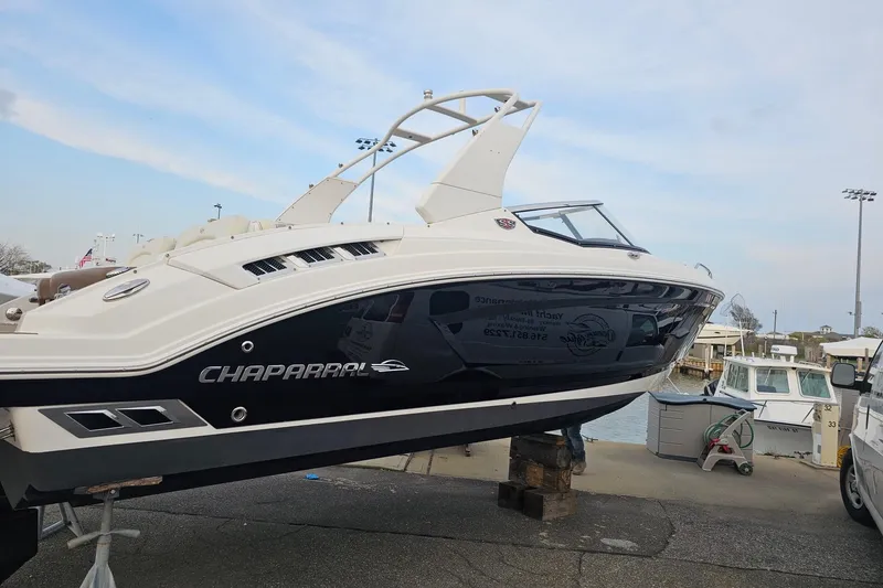 Slide: The Image of 2017 Chaparral 257 SSX boat on display at a marina, showcasing sleek design. - 4
