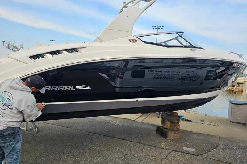Slide: The Image of 2017 Chaparral 257 SSX boat being detailed at a marina. - 5