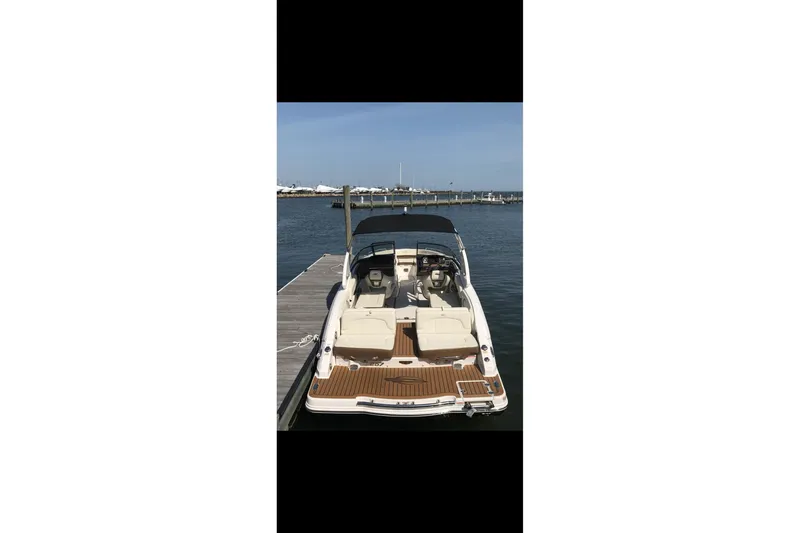 Slide: The Image of 2017 Chaparral 257 SSX boat docked at marina, rear view. - 7