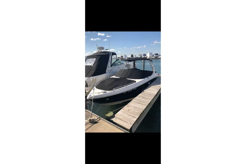 Slide: The Image of 2017 Chaparral 257 SSX boat docked at marina under clear blue sky. - 9