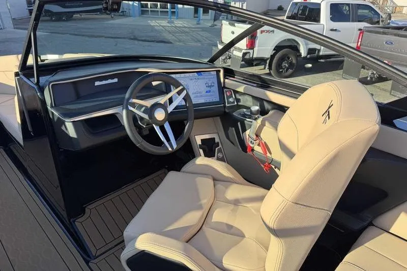 Slide: The Image of 2025 MasterCraft XT23 boat interior with modern dashboard and steering wheel. - 8