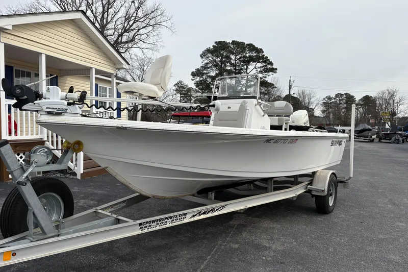 The Image of 2018 Sea Pro 208 Bay boat on trailer, parked outside a house. - 0