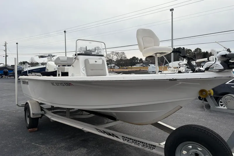 Slide: The Image of 2018 Sea Pro 208 Bay boat on trailer, displayed outdoors in a parking lot. - 3