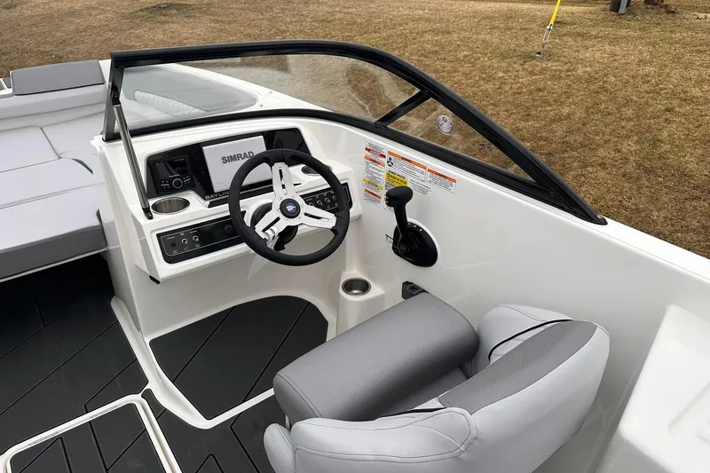 Slide: The Image of 2026 Bayliner D22 boat cockpit with steering wheel and Simrad display. - 11
