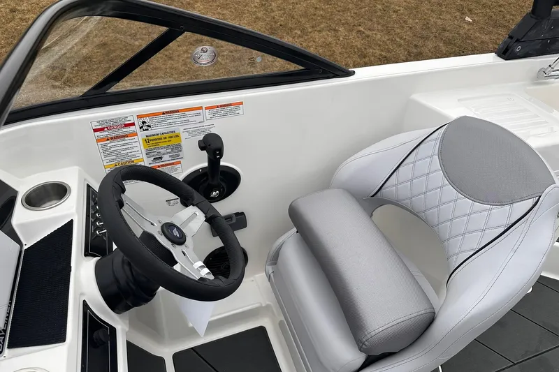 Slide: The Image of 2026 Bayliner D22 boat cockpit with steering wheel and cushioned seat. - 12