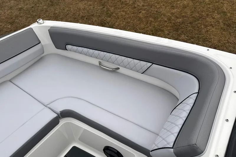 Slide: The Image of 2026 Bayliner D22 boat interior with gray and white cushioned seating. - 18