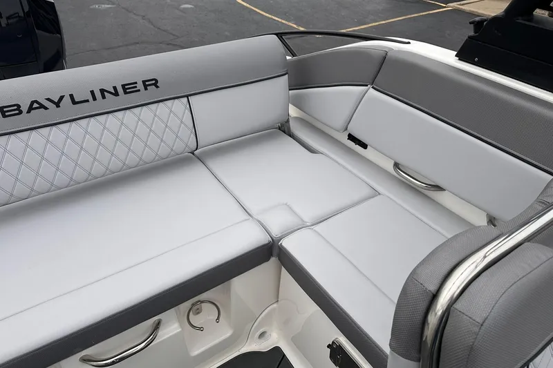Slide: The Image of 2026 Bayliner D22 boat interior with gray cushioned seating and diamond stitching. - 23