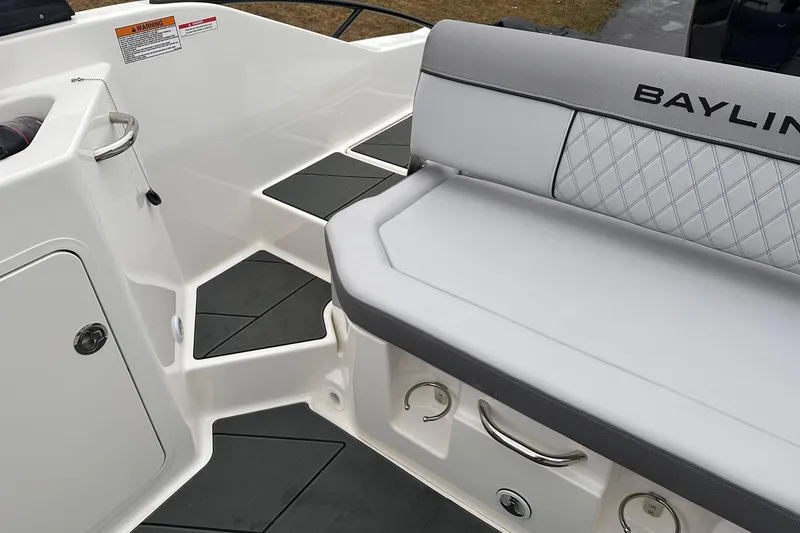Slide: The Image of 2026 Bayliner D22 boat interior with cushioned seating and storage compartments. - 25